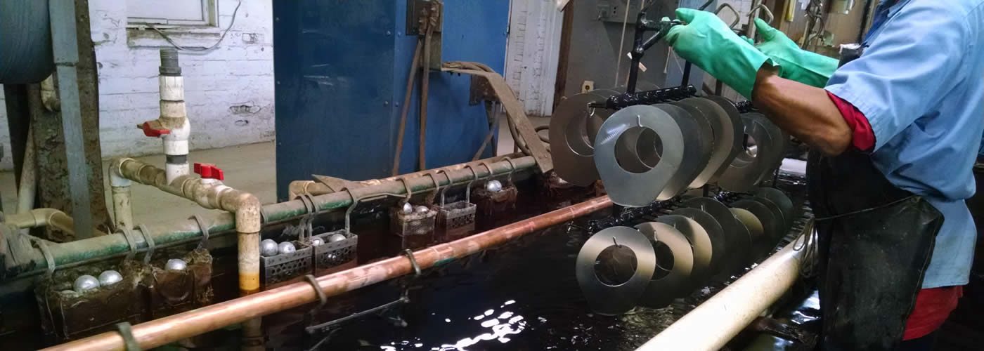 A plater running zinc parts on the line at Parker Metal Finishing